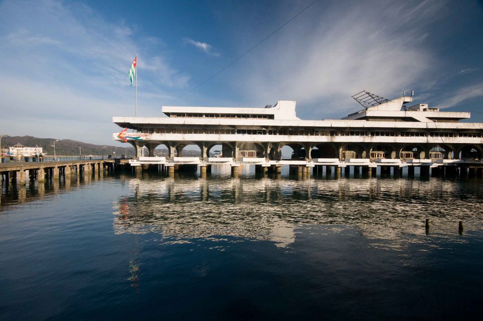 Deserted Sukhumi seaport pier with Abkhazian flag