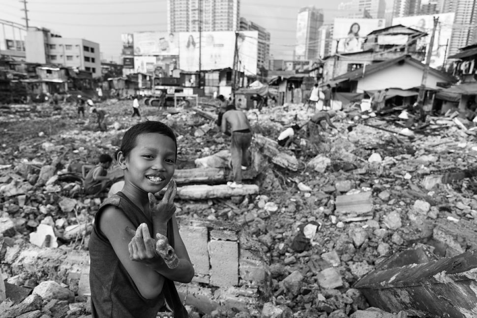 Child with a hammer in the debris