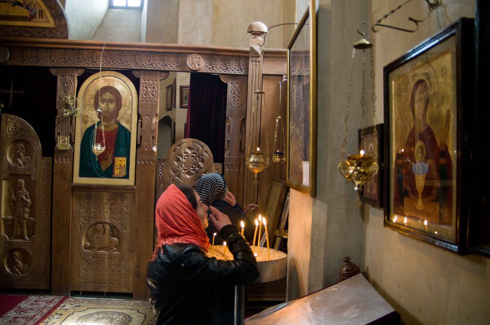 Touching the icon, Kazbegi church