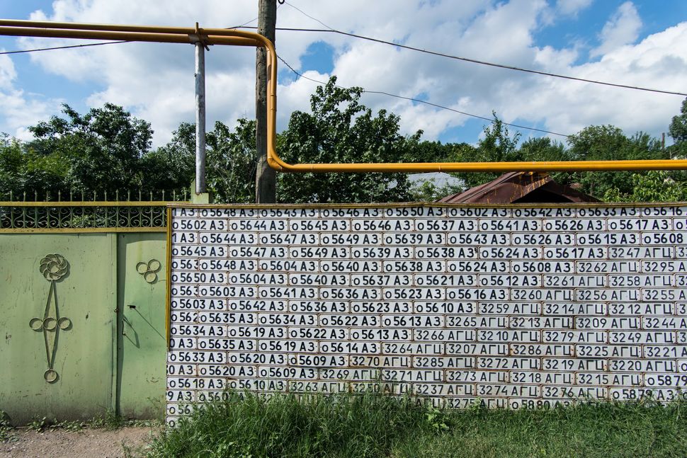 Street wall made of Azeri license plates