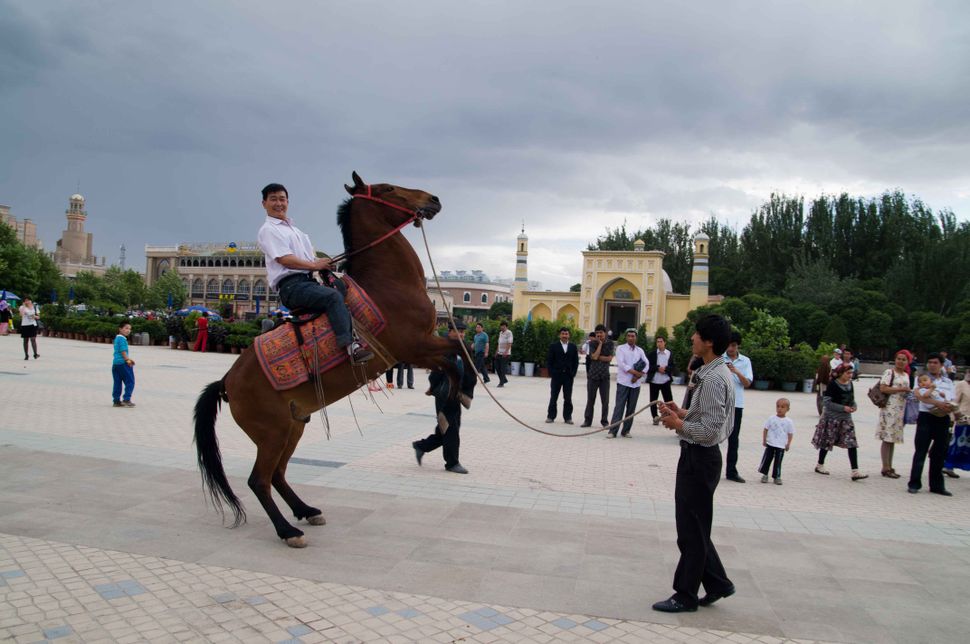 Horse riding in front of id Kah Mosque, Kashgar