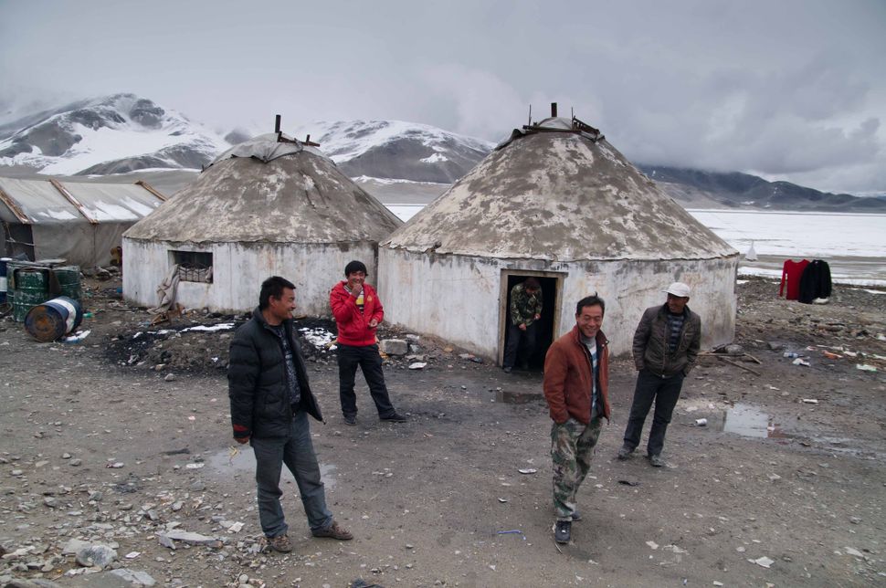Uyghurs near yurts at Lake Karakul