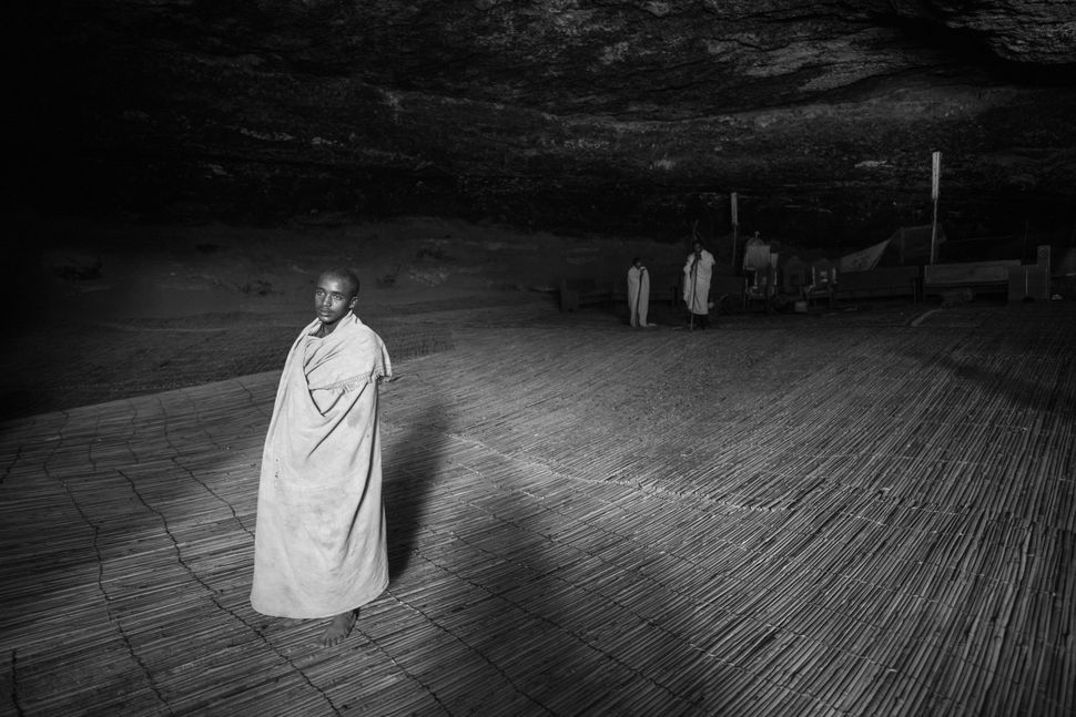 Deacon in the cave of Yemrehanna Kristos church